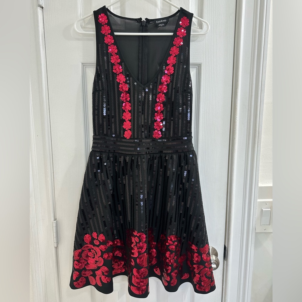 BEBE Women’s dress. Black and red sequels. Like new and used with love. Medium